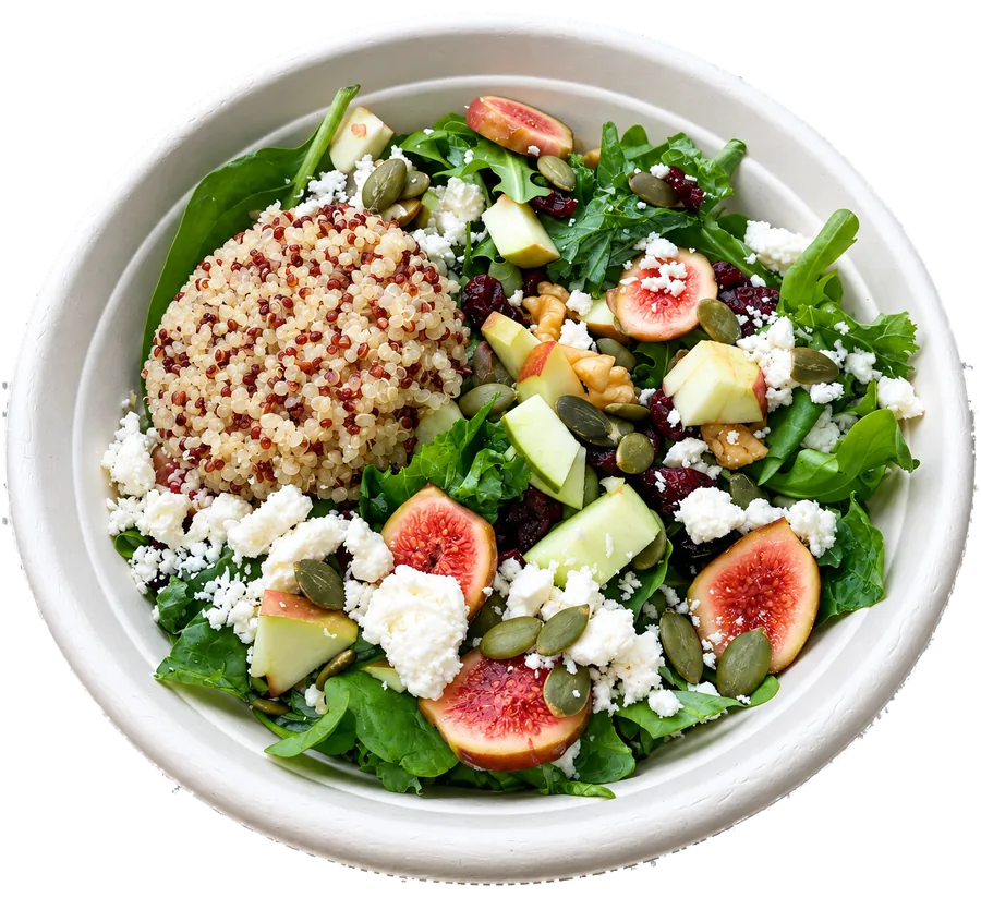 A quinoa bowl with greens, fresh figs, apple and feta